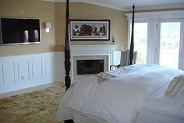 Classic Raised Panel Wainscoting and Mantel in a bedroom.  Wainscoting Ideas by Wainscoting America