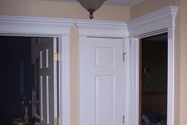 Wainscoting America pediment heads with fluted pilasters.  The pediment heads are mitered in the corner