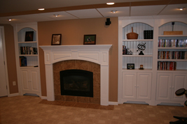Wainscoting America Raised Panel Arched Mantel with Fluted Pilasters and Built-in Bookcases