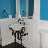 Classic Raised Panel wainscoting and recessed panel columns with Kohler Iron Works sink.