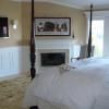 Classic Raised Panel Wainscoting with fireplace mantel in a Bedroom