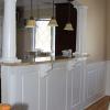 Beaded Raised Panel Wainscot in a dining room in Bellmore, NY.  The half wall has a granite top and the raised panel is offset with fluted pilasters below the columns
