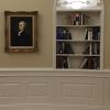 Alexander Hamilton Portrait in Oval office next to bookcase with shell motif.  Replica Office by Oval Office Design LLC.