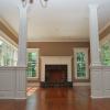 Raised Panel half walls with Raised Panel Columns.  In the background is a Recessed Panel Mantel centered between 2 windows with Pediment Head millwork