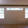 Full bedroom wall of raised panels with pediment head and pilasters